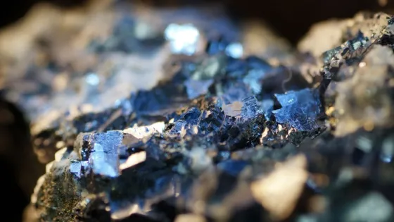 Close-up of shimmering, crystalline minerals with jagged edges and reflective surfaces.