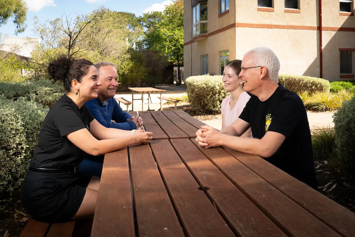 Four scientists at a table