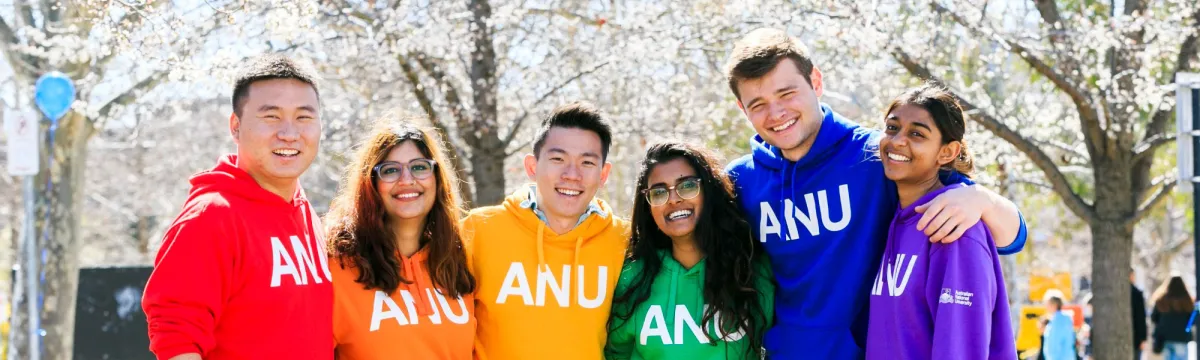 Students wearing ANU hoodies in different colours