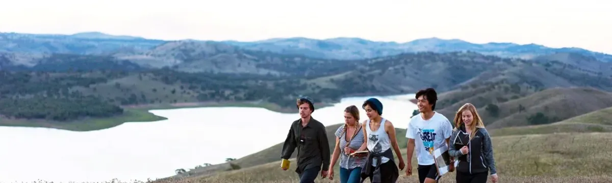 People walking along a river