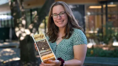Alysha with her sediment core inspired cake